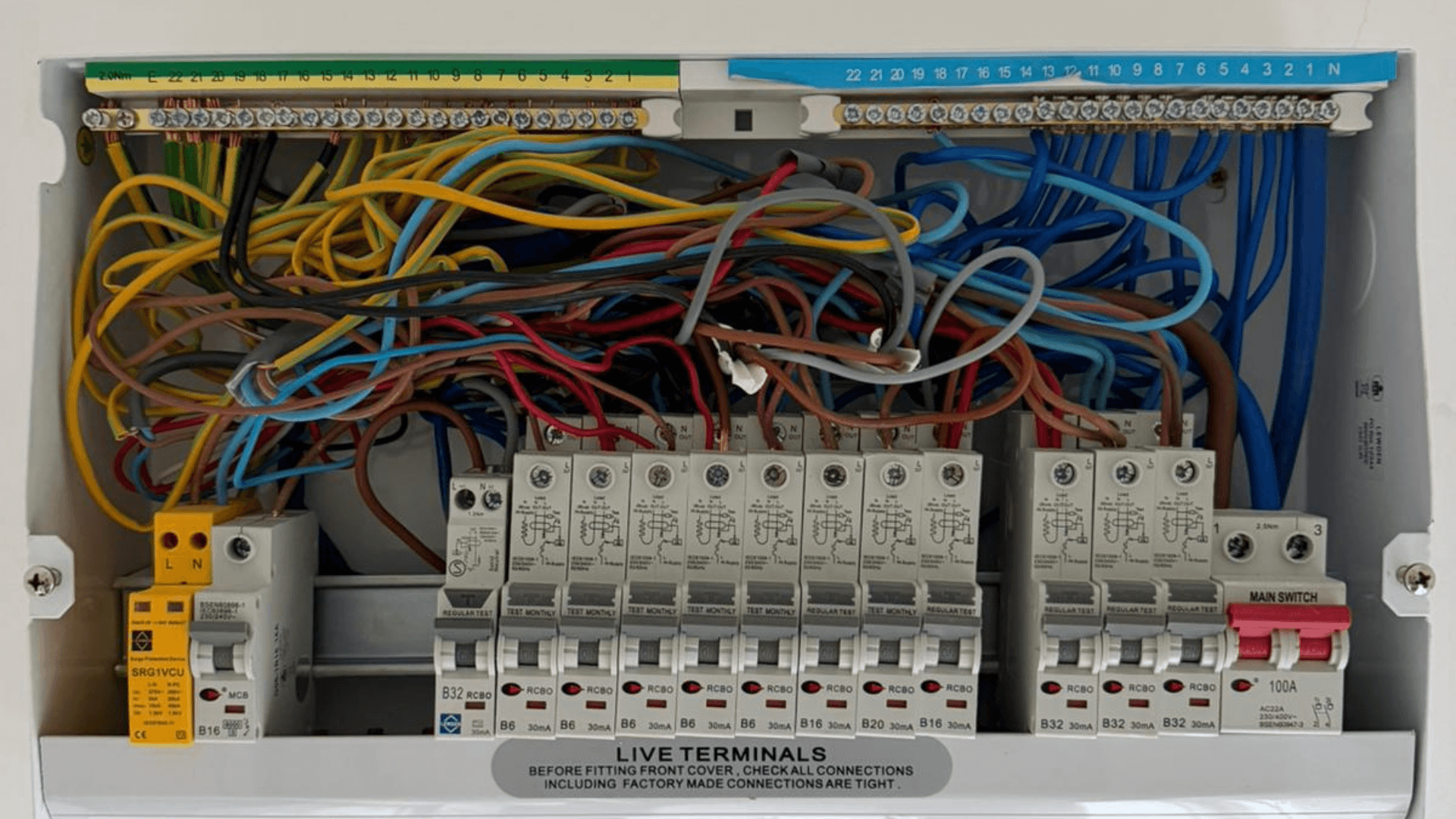 Consumer unit before cable tidying with crowded and tangled wiring